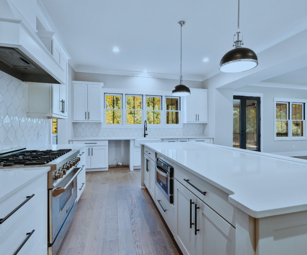 Modern white kitchen remodel featuring custom cabinetry and island in Loveland, Colorado.